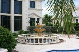 Natural Patina on a 3 tier The trickle effect stone outdoor water fountains set in the center of a patio.